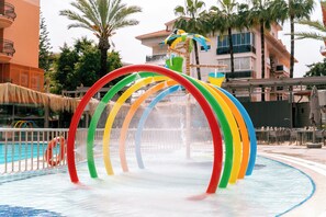 A water play area with a colorful arch structure and a pool. - Calimera Sunpark Alanya (Alanya)