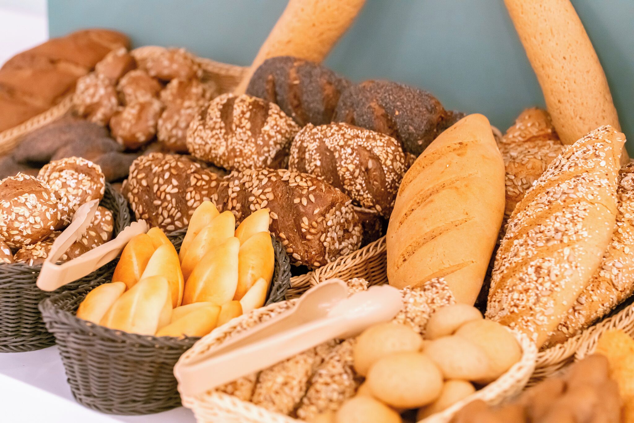 A variety of breads and rolls in baskets.