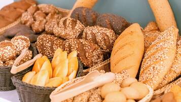 A variety of breads and rolls in baskets.