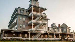 A multi-story building with a porch and a sign that reads "SUMMERCAMP". - Summercamp (Oak Bluffs)