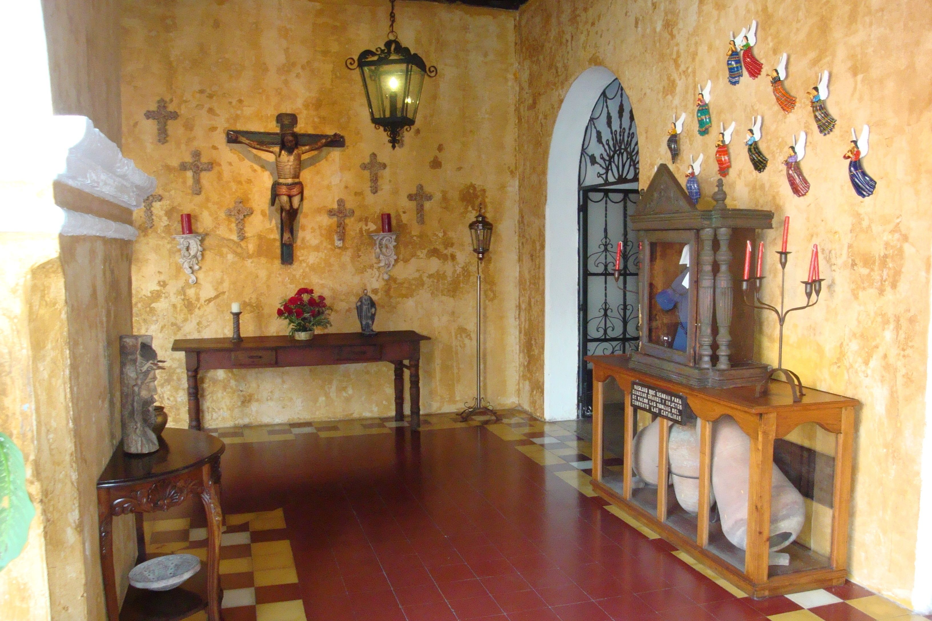 A church interior with a wooden altar, crucifix, and several candles.
