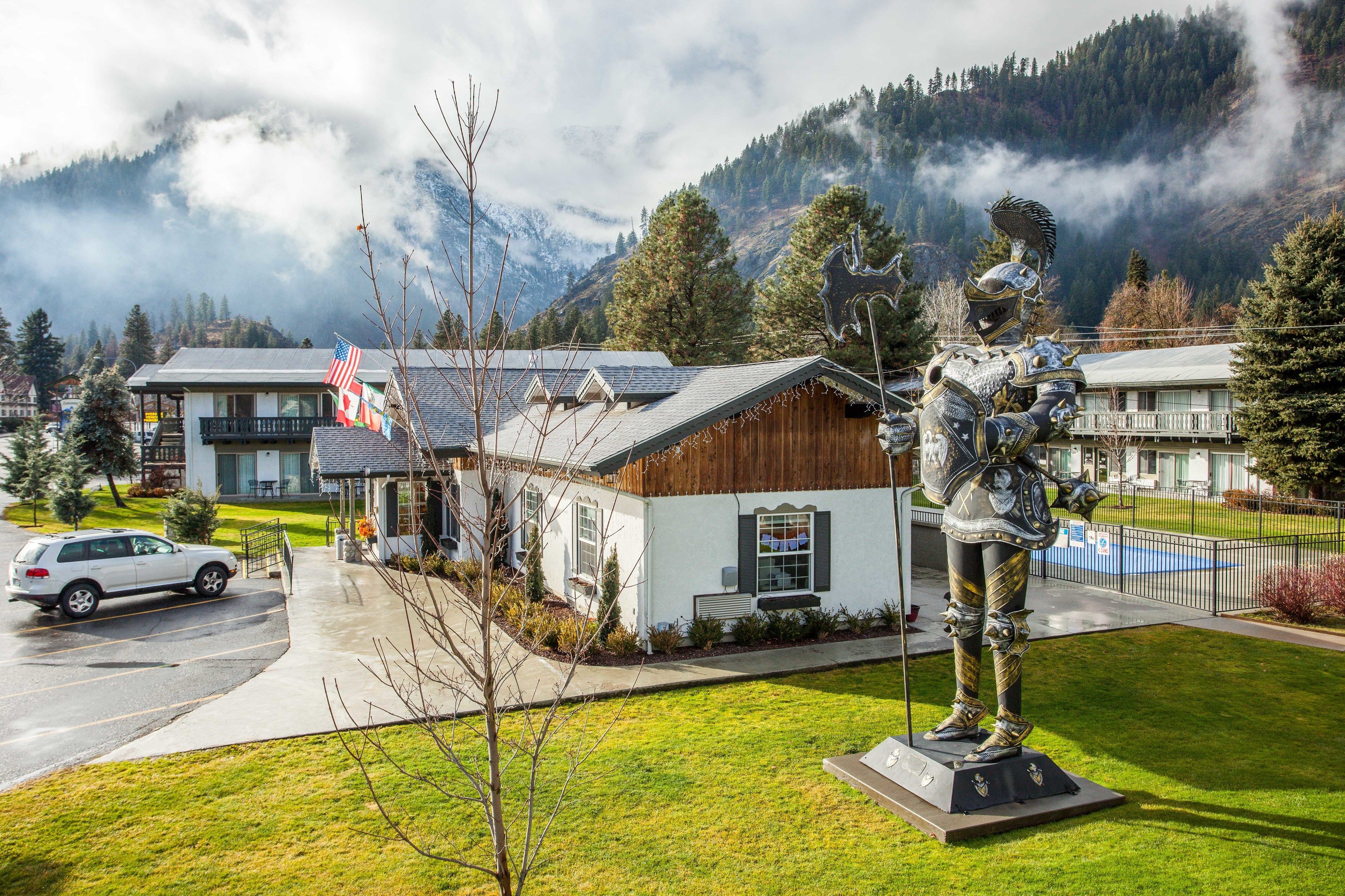 Un bâtiment à l’extérieur en bois, doté d’un petit porche et orné d’une statue devant l’entrée.