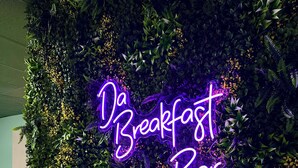 A neon sign reading "Da Breakfast Bar" against a backdrop of lush greenery. - Sun Fun Resort (Nassau)