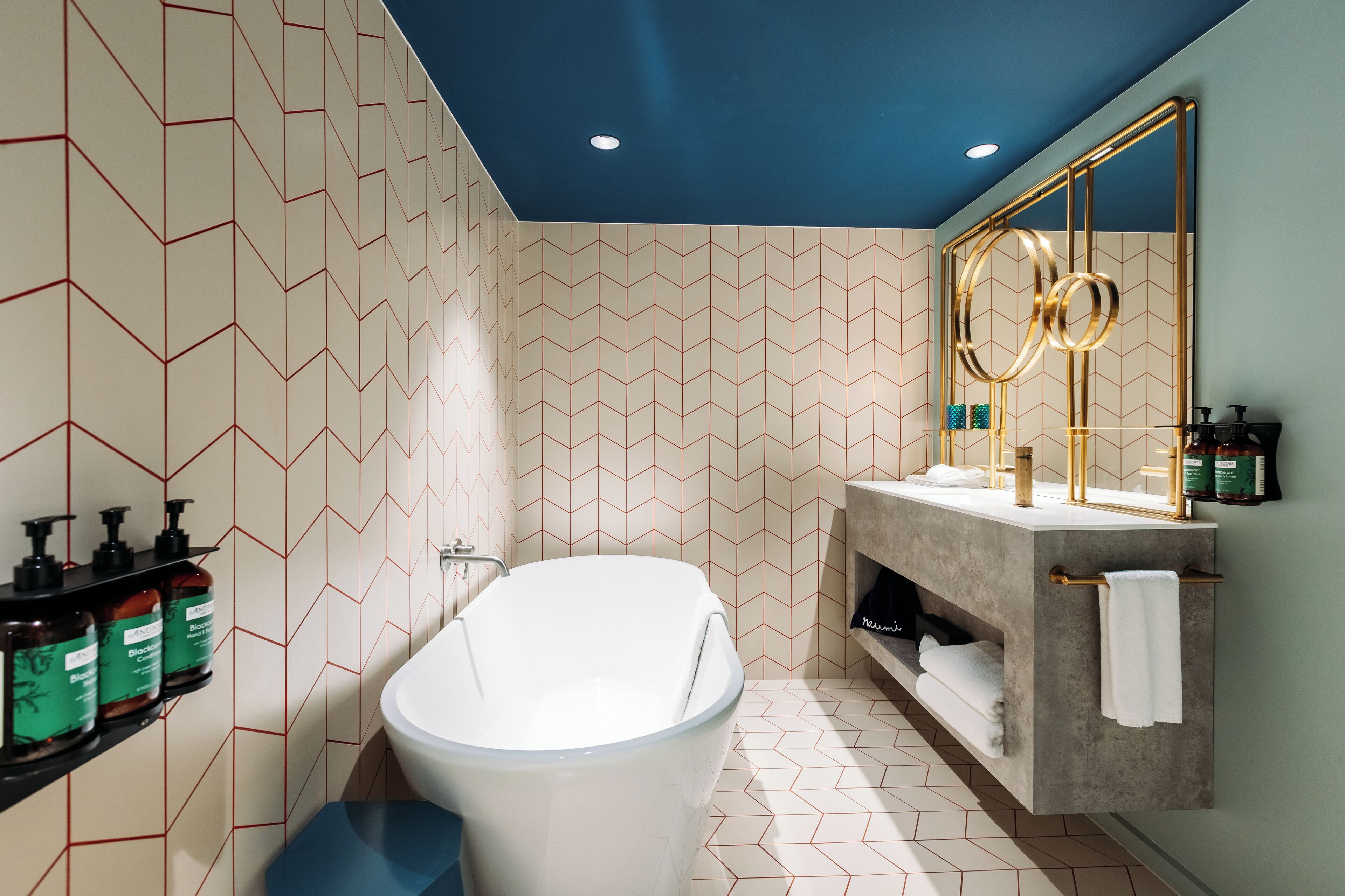 A modern bathroom with a freestanding bathtub, a vanity with a mirror, and a shower area.