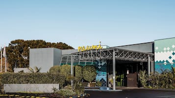 A hotel entrance with a modern design, including a metal canopy and a sign with a number.