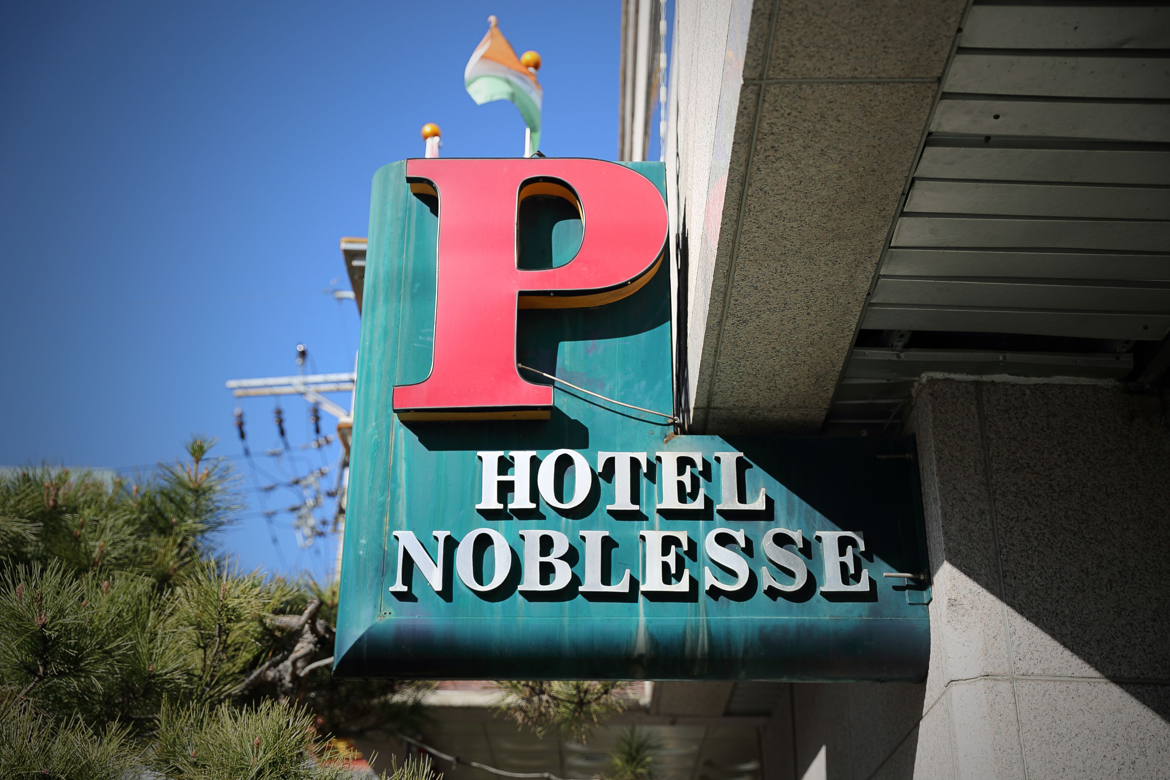 Un letrero de hotel con una 'P' destacada y el nombre 'HOTEL NOBLESSE'.