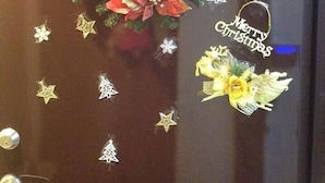 A door with a Christmas wreath, stars, and a 'Merry Christmas' sticker. - Come Inn Taipei 3 (Taipei)
