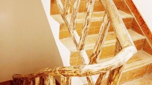 A wooden staircase with a rustic design, featuring a handrail made of natural wood logs. - Zhang Jiajie Longquan Inn (Zhangjiajie)