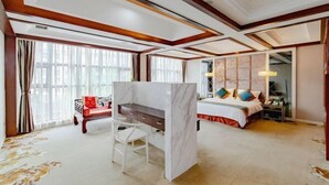 A hotel room with a bed, a desk, a chair, and a large window. - Huaxi Hotel Dujiangyan (Chengdu)