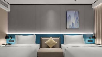 A modern hotel room with two beds, a central seating area, and a large artwork on the wall.