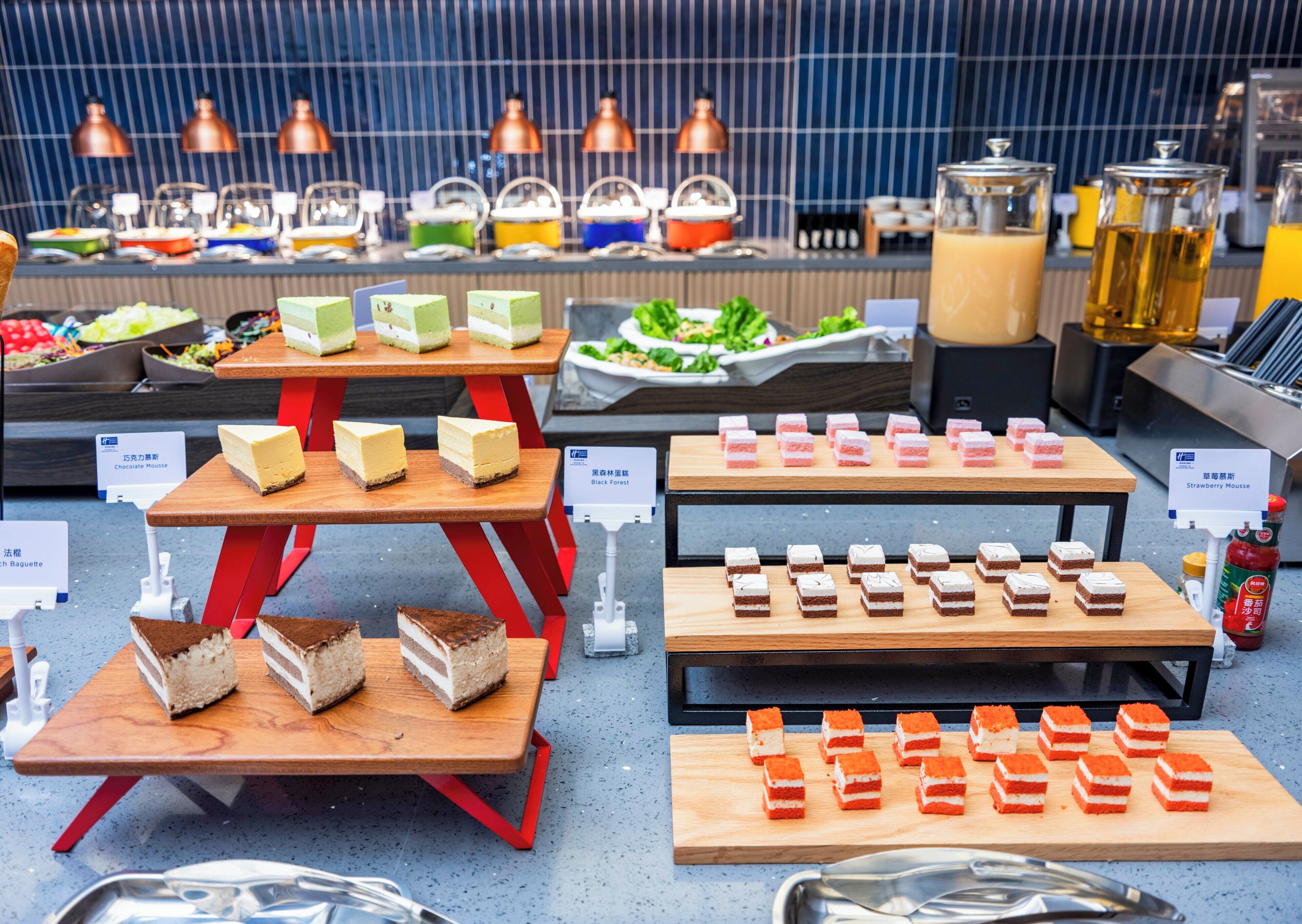 A buffet with various desserts and beverages.