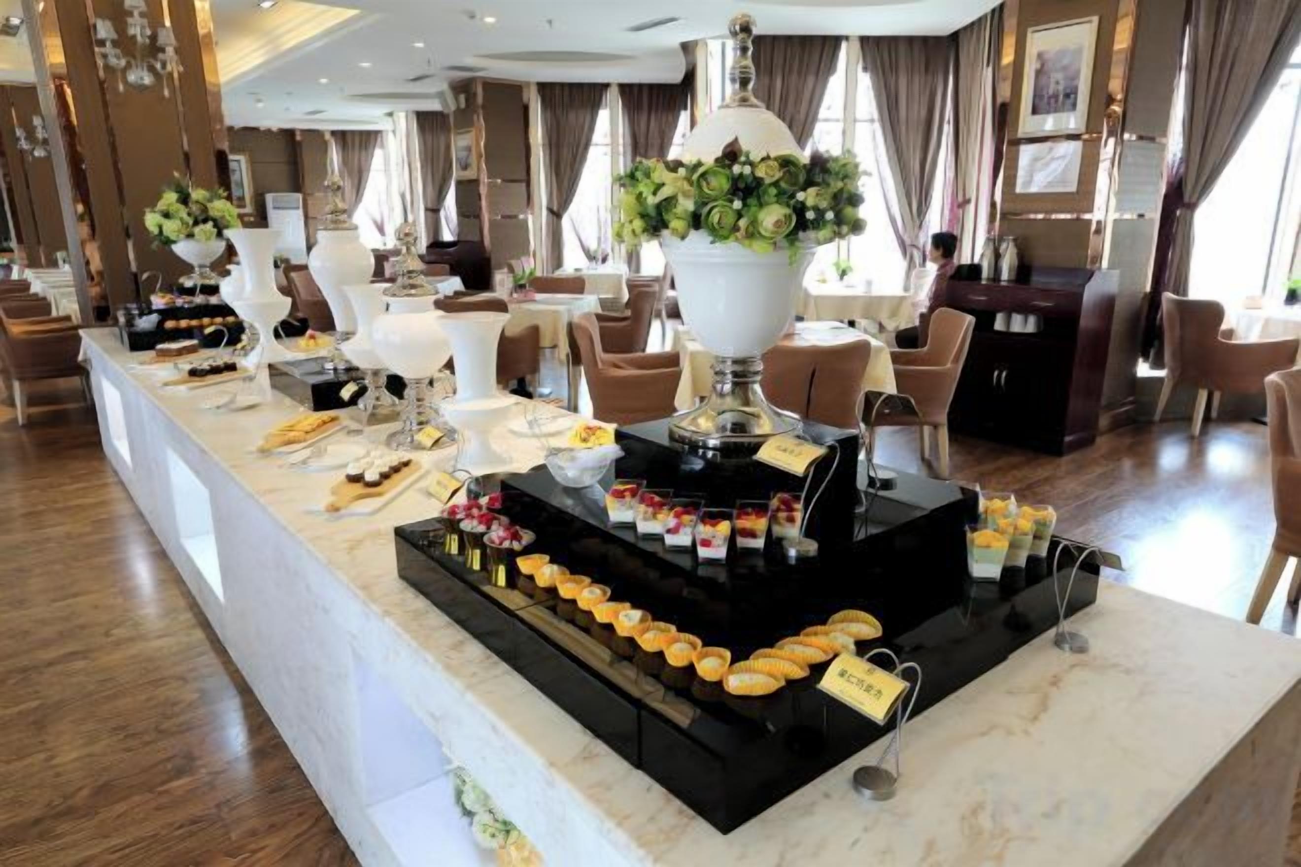 A buffet setup with various food items and a centerpiece.