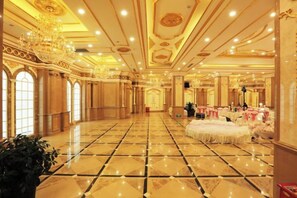 A spacious ballroom with a polished floor, ornate ceiling, and chandeliers. - Korla Pear City Garden Hotel (Korla)