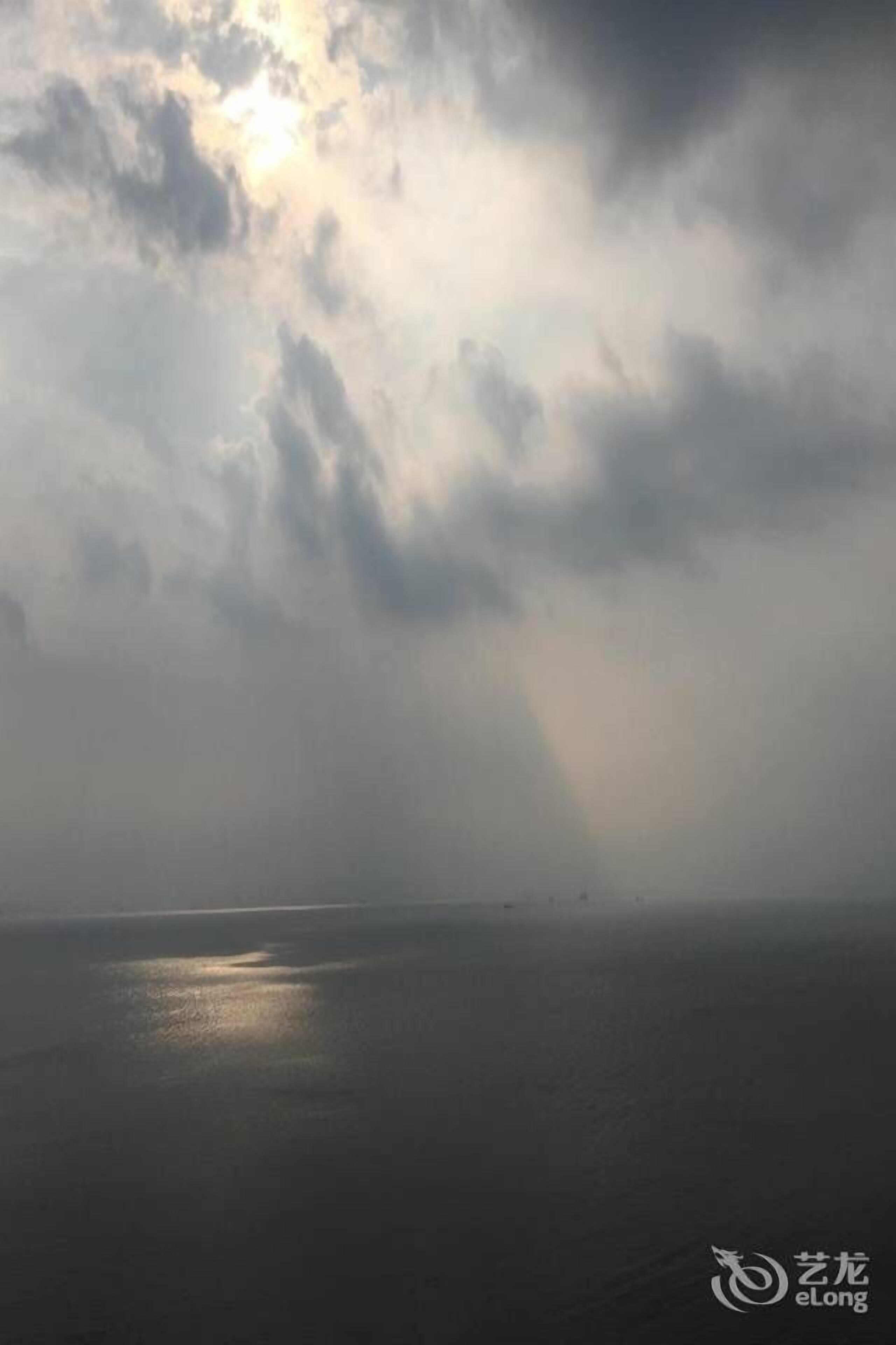 A view of a body of water under a cloudy sky.