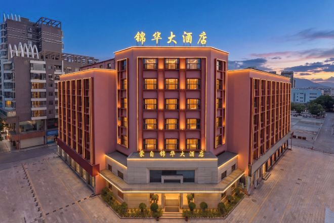 A hotel with a modern design, featuring a prominent entrance and multiple floors.