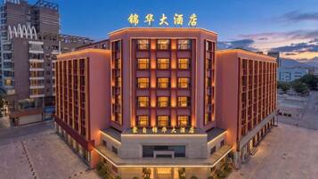 A hotel with a modern design, featuring a prominent entrance and multiple floors.