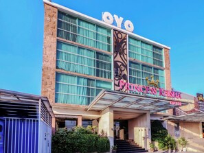 A hotel with a large sign reading 'Princess Kelsia Hotel' and a prominent 'YOYO' sign above it. - Princess Keisha Hotel (Denpasar)