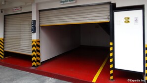 A hotel entrance with a red carpet leading to a closed room marked "Regular Room." - Hotel Sogo Quirino Motor Drive Inn (Manila)