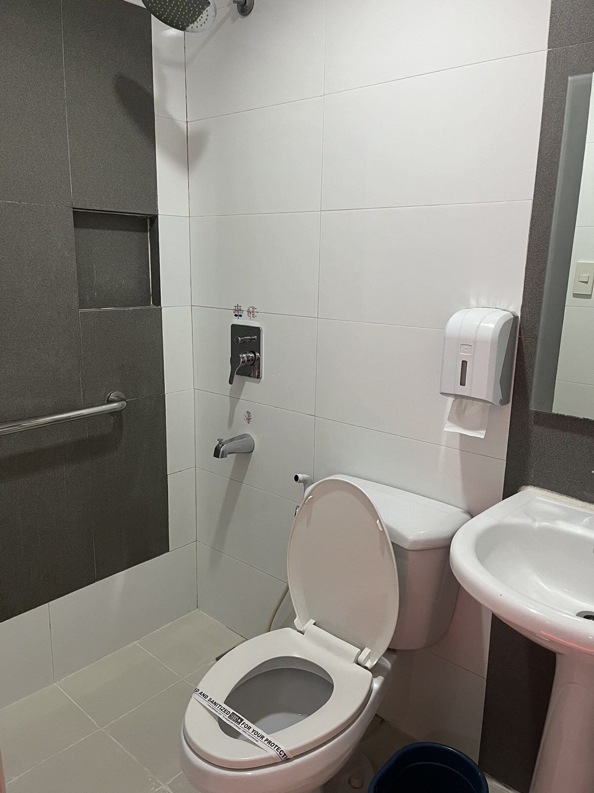 A modern bathroom with a toilet, bidet, and sink.