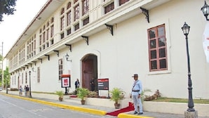 A building with a white facade, multiple windows, and a red carpet leading to the entrance. - Hotel Sogo Quirino Motor Drive Inn (Manila)