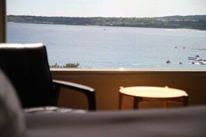 A view from a room with a large window overlooking a body of water with boats. - Just Hi Seaview B&B (Hengchun)