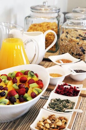 A breakfast buffet with various fruits, cereals, and beverages. - Kingsmead Guest House (Harare)
