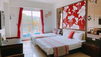 A hotel room with two beds, a balcony, and a large decorative wall.