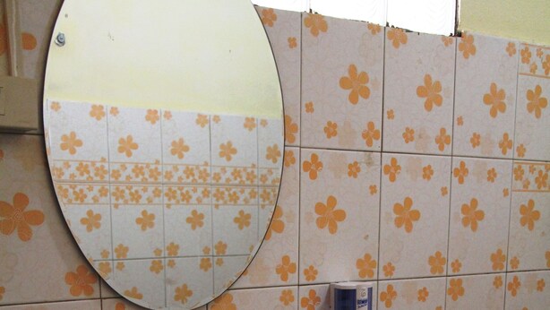 A bathroom with a sink, mirror, and hand soap dispenser. - Thida Guesthouse (Luang Prabang)
