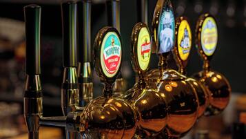 A row of beer taps with labels for Murphy's Irish Red and Krusky.