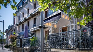 A hotel with a sign reading "Gilles Moreau" and a restaurant sign "Le RESTAURANT" below it. - Gilles Moreau (Laguiole)