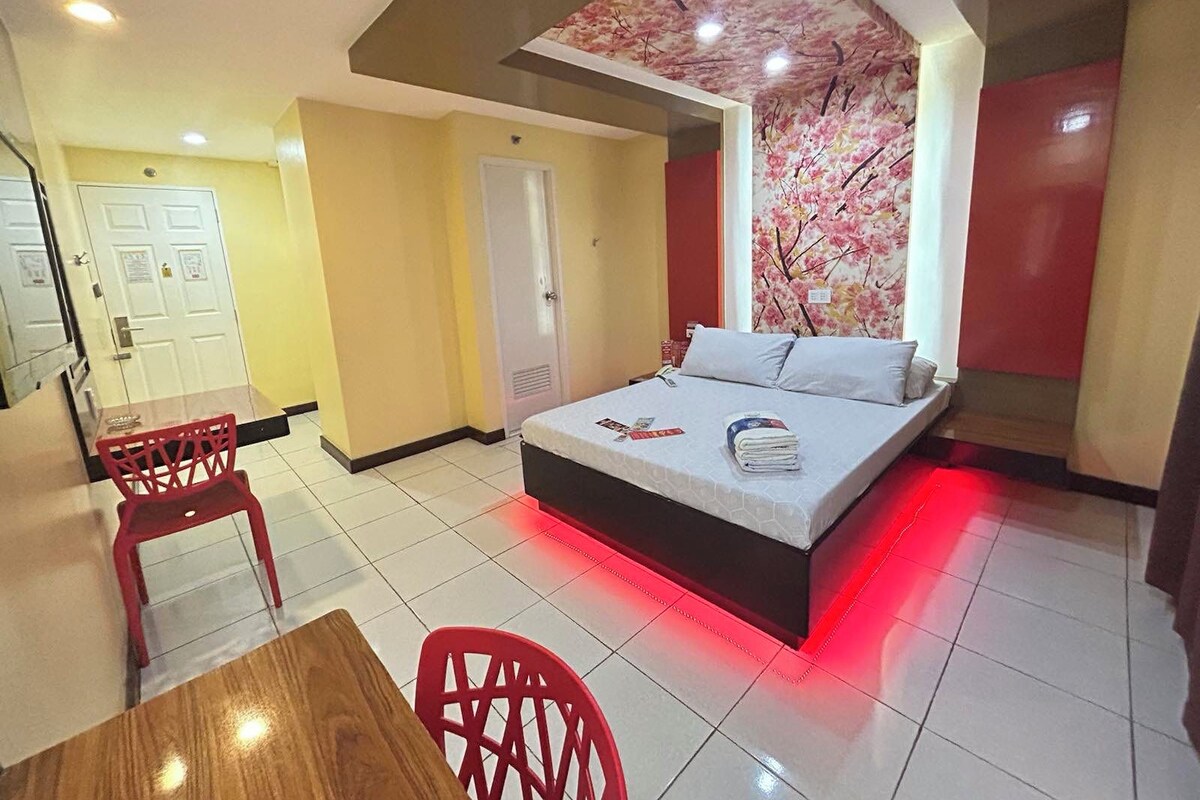 Una habitación de hotel con cama, escritorio y silla.