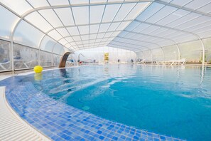 Indoor pool, outdoor pool, pool umbrellas, pool loungers