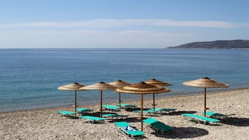 On the beach, sun loungers, beach umbrellas