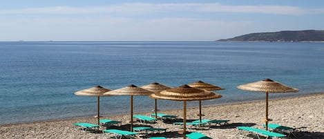 On the beach, sun loungers, beach umbrellas