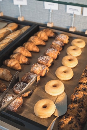 A bakery display with various baked goods including croissants, donuts, and cookies. - The Red Hotel by Ibiza Feeling - Adults only (Sant Antoni de Portmany)
