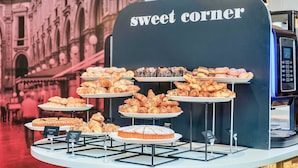 A bakery display with various pastries and a coffee machine. - B&B Hotel Milano Sant'Ambrogio (Milan)
