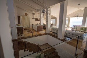 A spacious living area with a staircase, a dining area, and a kitchen. - Spa Resort Becici (Becici)