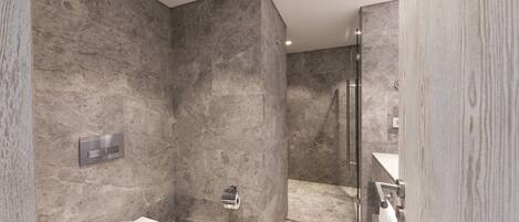 A modern bathroom with a marble wall, a toilet, a shower area, and a wooden door.