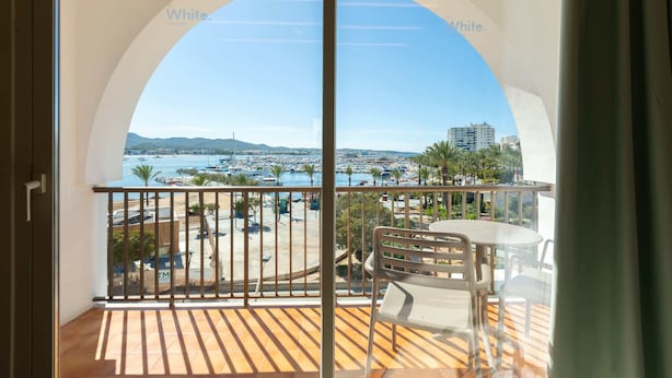 A balcony with a view of a marina and buildings. - The White Apartments by Ibiza Feeling - Adults Only (Sant Antoni de Portmany)