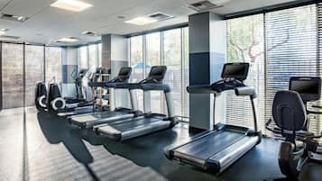 A gym with treadmills, elliptical machines, and exercise bikes.