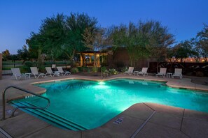 Una piscina al aire libre, sombrillas, tumbonas