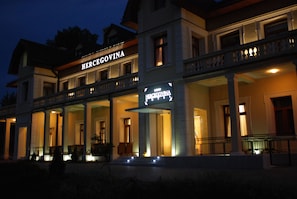 A two-story building with a sign reading "HERCEGOVINA" at the entrance. - Hotel Hercegovina (Sarajevo)