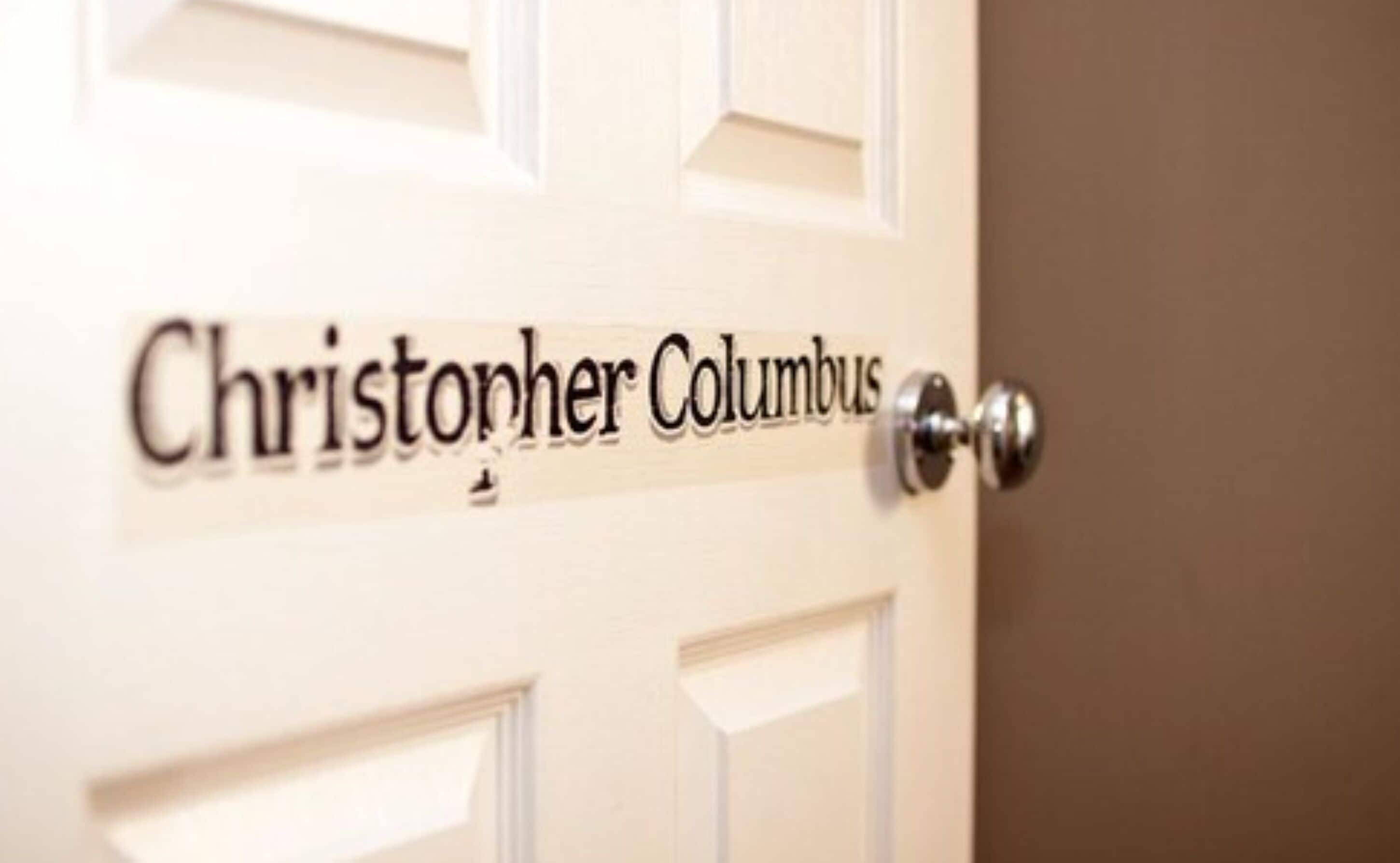 A door with a nameplate reading "Christopher Columbus".