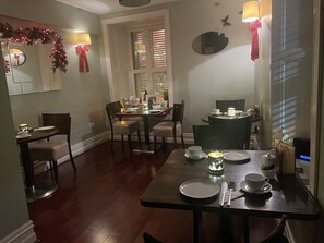 Enjoy meals in the comfort of your room at this hotel, where a dining table for two is set with fine china and a lamp adds warm ambiance.