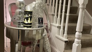 A staircase with white balusters and a chandelier with a black shade. - 7 Cross Street (Galway)