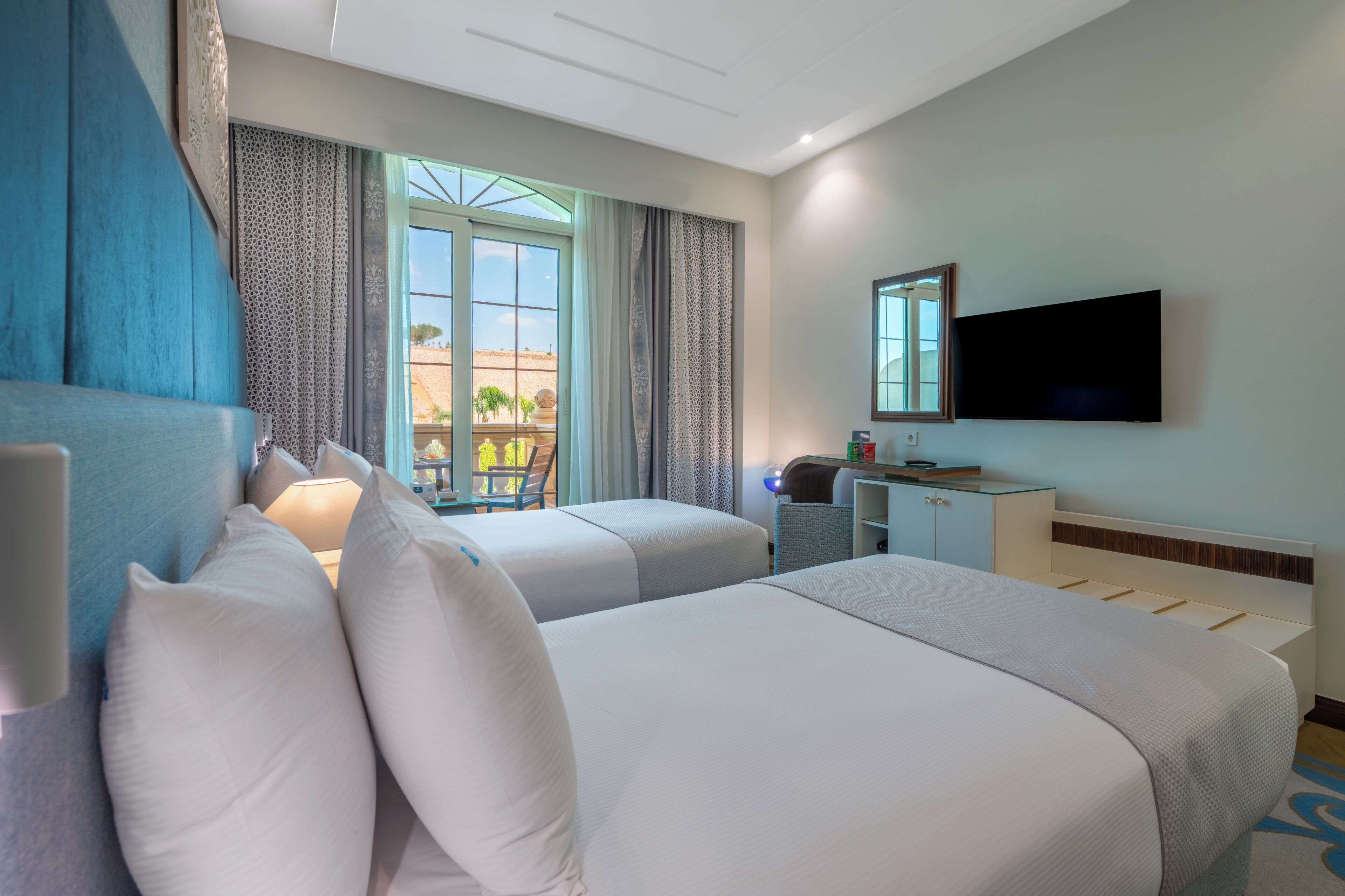 Deluxe Room | Minibar, in-room safe, laptop workspace, blackout curtains