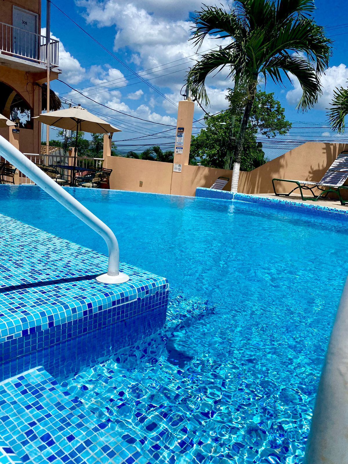 outdoor pool, open 9 am to 8 pm, pool umbrellas, pool loungers