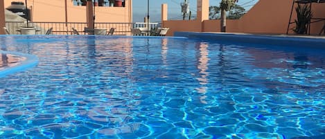 Outdoor pool, open 9 AM to 8 PM, pool umbrellas, pool loungers