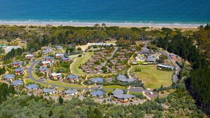 An aerial view of a residential area with houses, roads, and a beach.