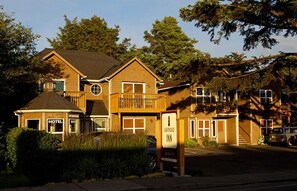 A two-story building with a 'HOTEL' sign, a 'Lighthouse Inn' sign, and a balcony.